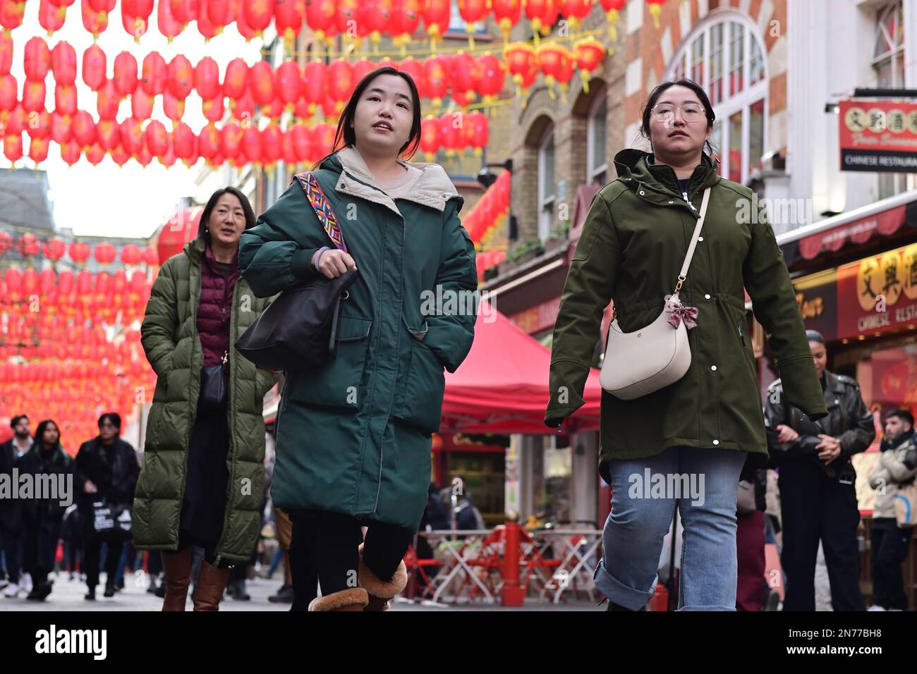 London, UK. 4 February 2023. Tourists sightseeing and chinese red lanterns in Chinatown, London
