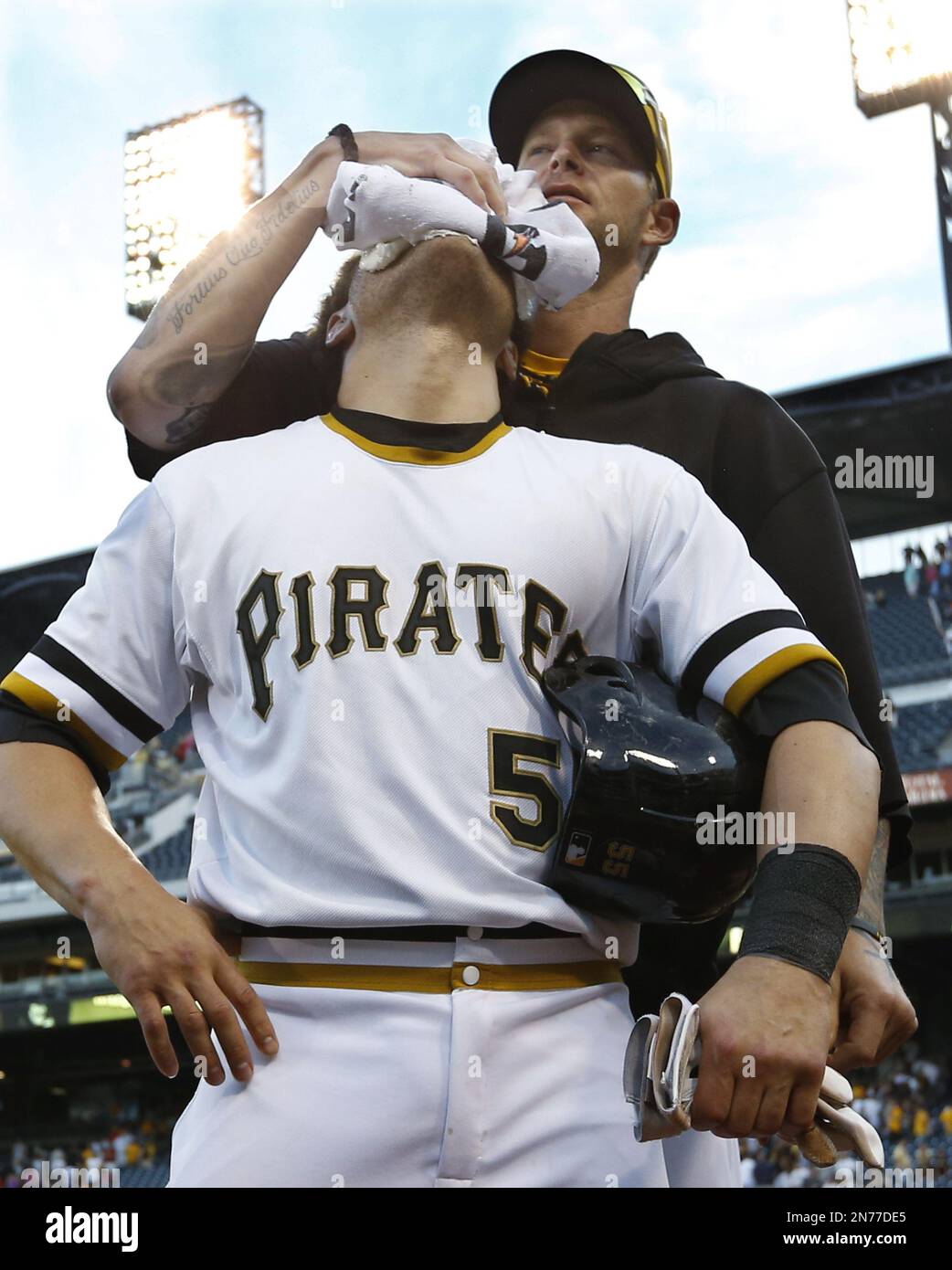 Pittsburgh Pirates' Russell Martin (55) gets a facefull of cream in  celebration from Pittsburgh Pirates' A.J. Burnett after Martin drove in  Gaby Sanchez with the game winning hit in the fourteenth inning