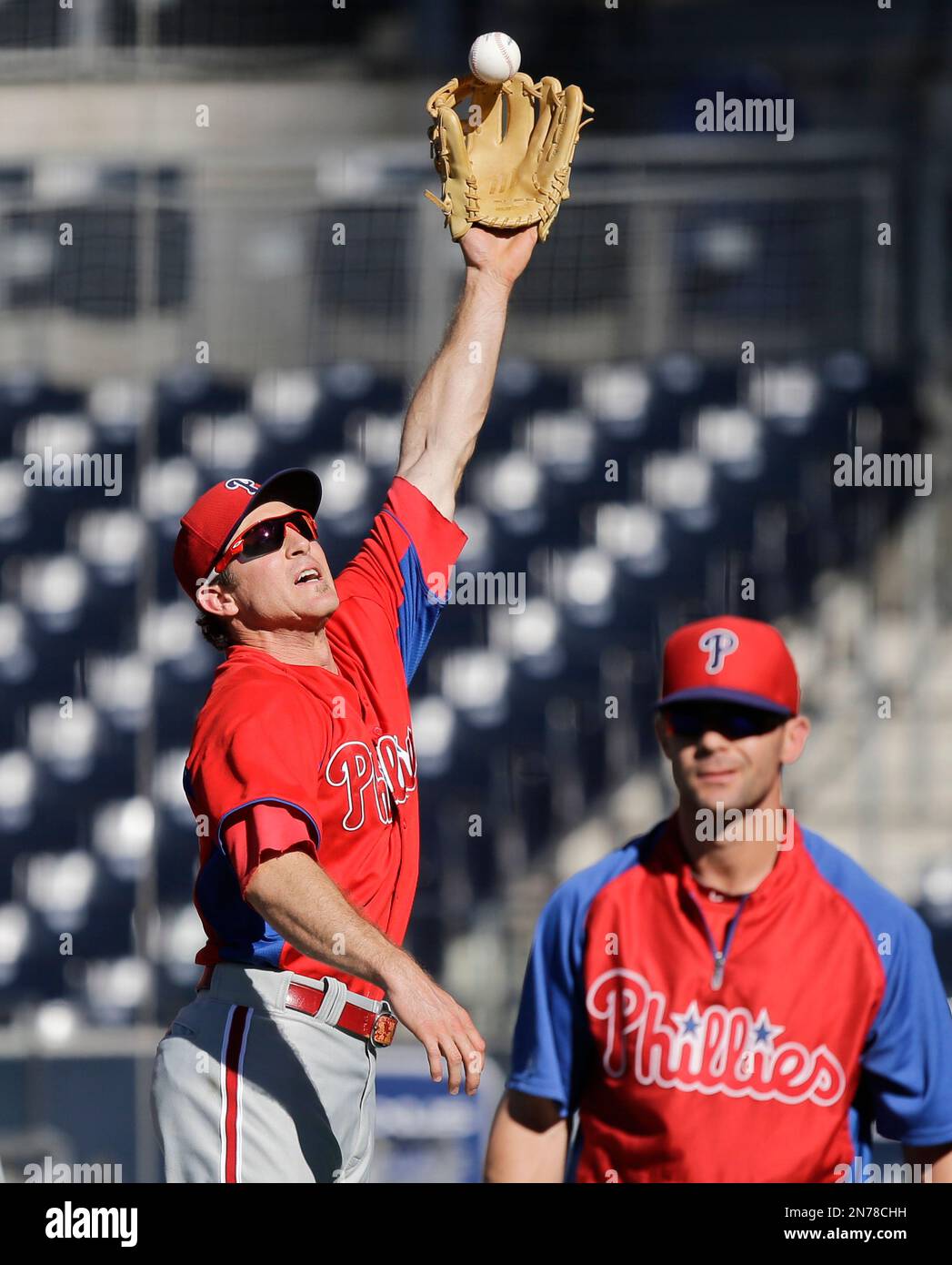 Former Philadelphia Phillies' Chase Utley, right, throws a