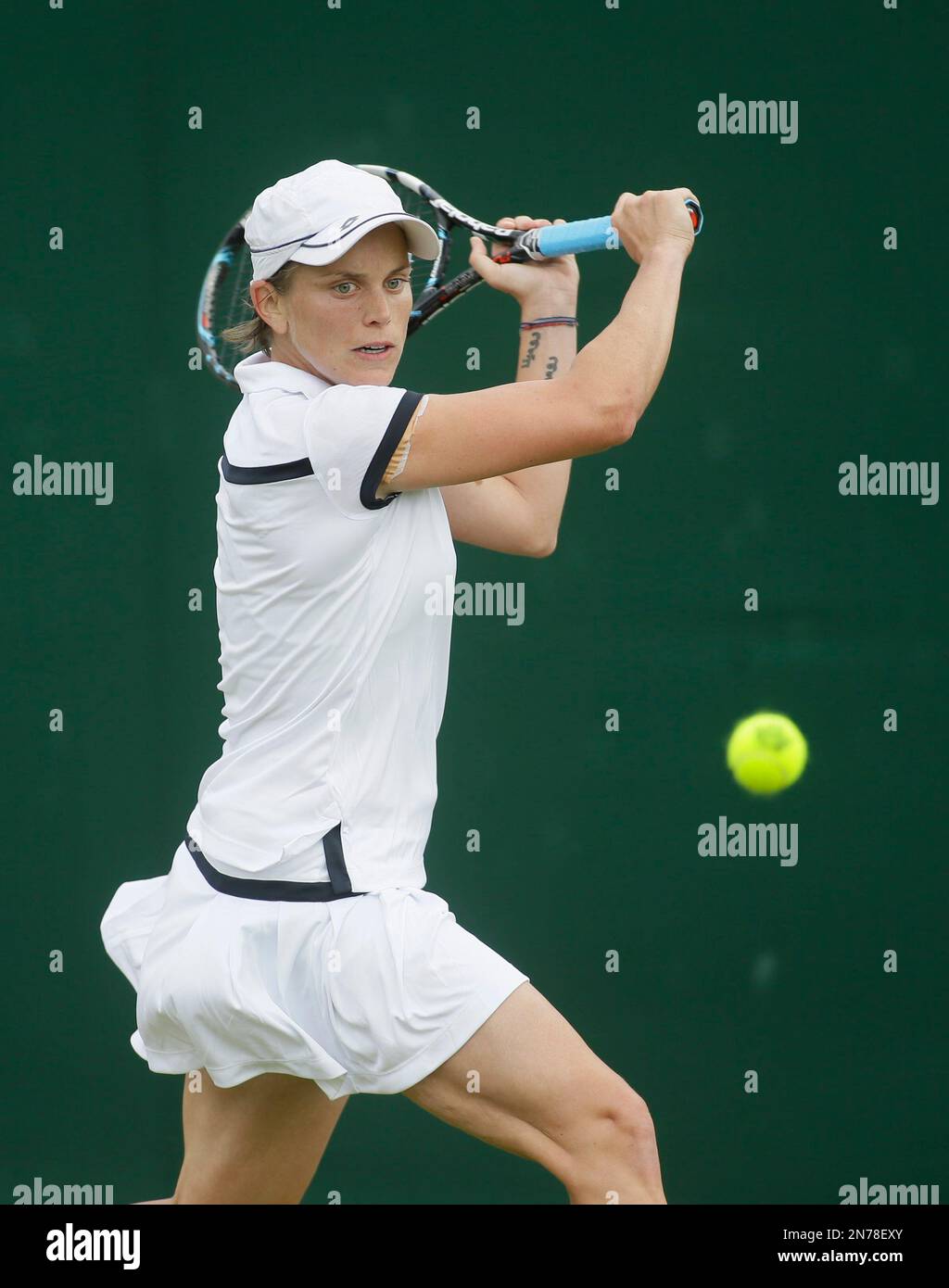 Romina Oprandi of Switzerland plays a shot to Alison Riske of the United States during their Women's first round singles match at the All England Lawn Tennis Championships in Wimbledon, London, Tuesday, June 25, 2013. (AP Photo/Alastair Grant) Stock Photo