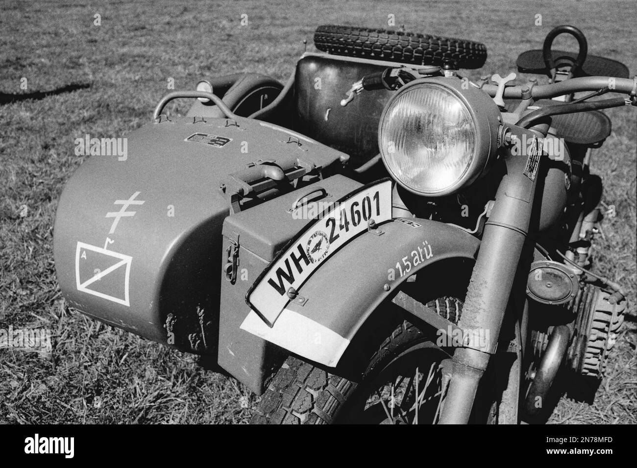 WWII BMW motorcycle parked at a camp in a field during a reenactment at the American Heritage Museum. The image was captured on analog black and white Stock Photo