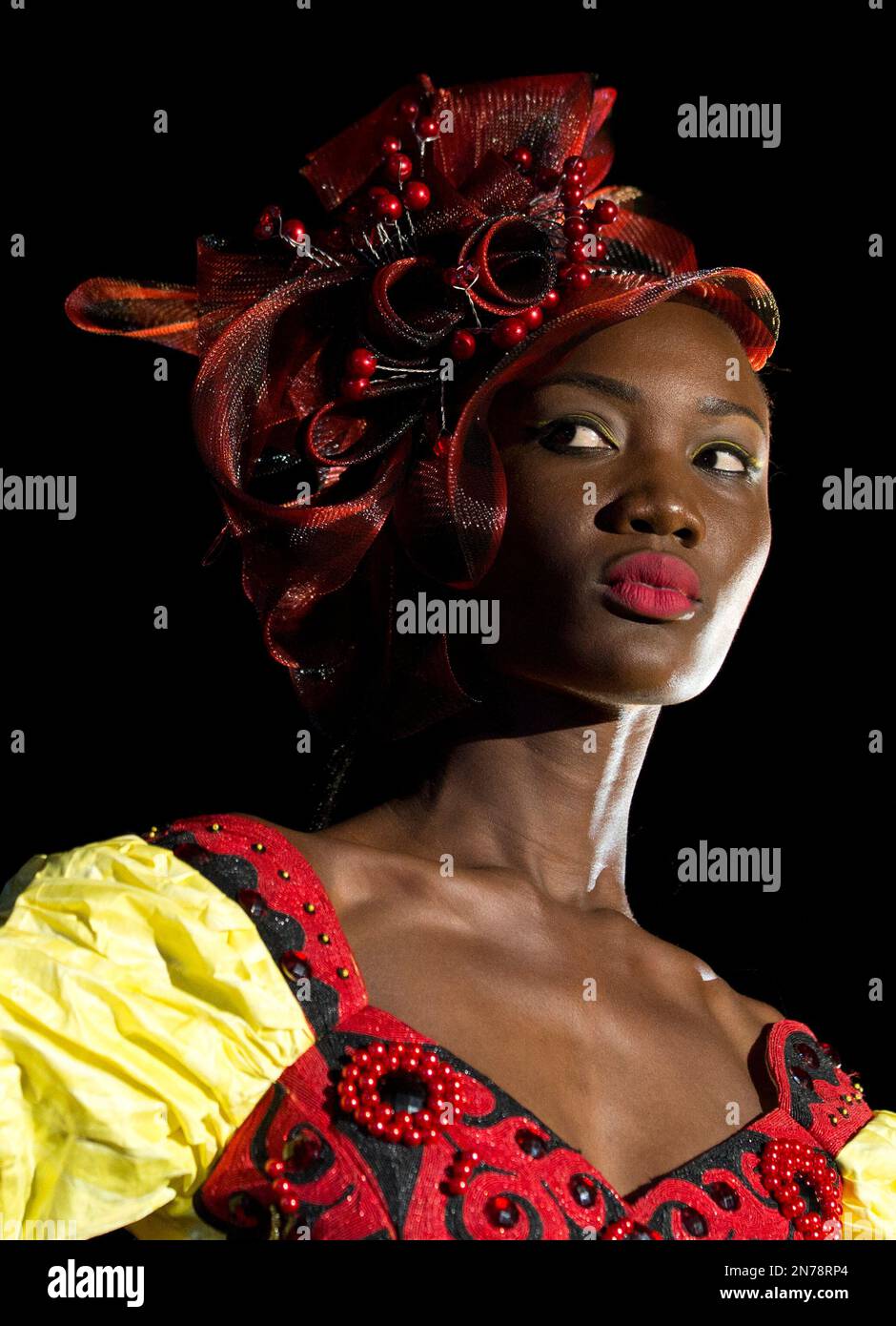 In this Friday, June 21, 2013 photo, a model wears a creation by Senegalese  designer Tapha Fall, of Bara Couture, during a runway show in Guediawaye,  outside Dakar, Senegal. After a Friday