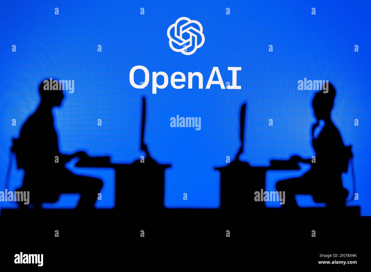 INDIA, NEW DELHI. JANUARY 30, 2023: Open AI. Collaboration Leads to Progress: Two Developers Working Together Under the Company's Logo Stock Photo