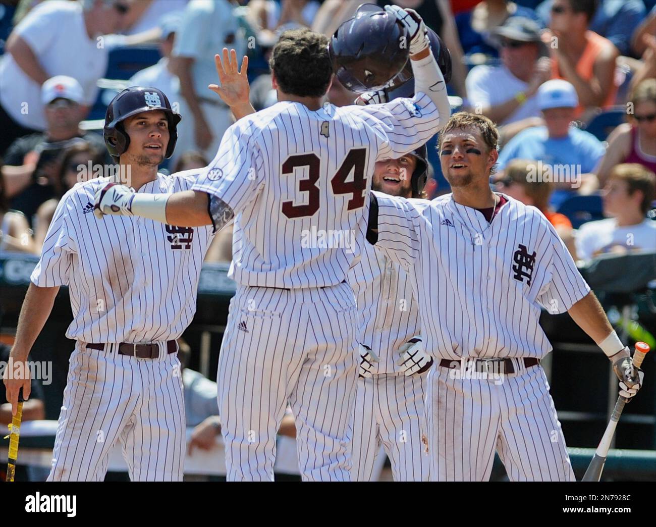 Mississippi State's Hunter Renfroe (34) is greeted by teammates