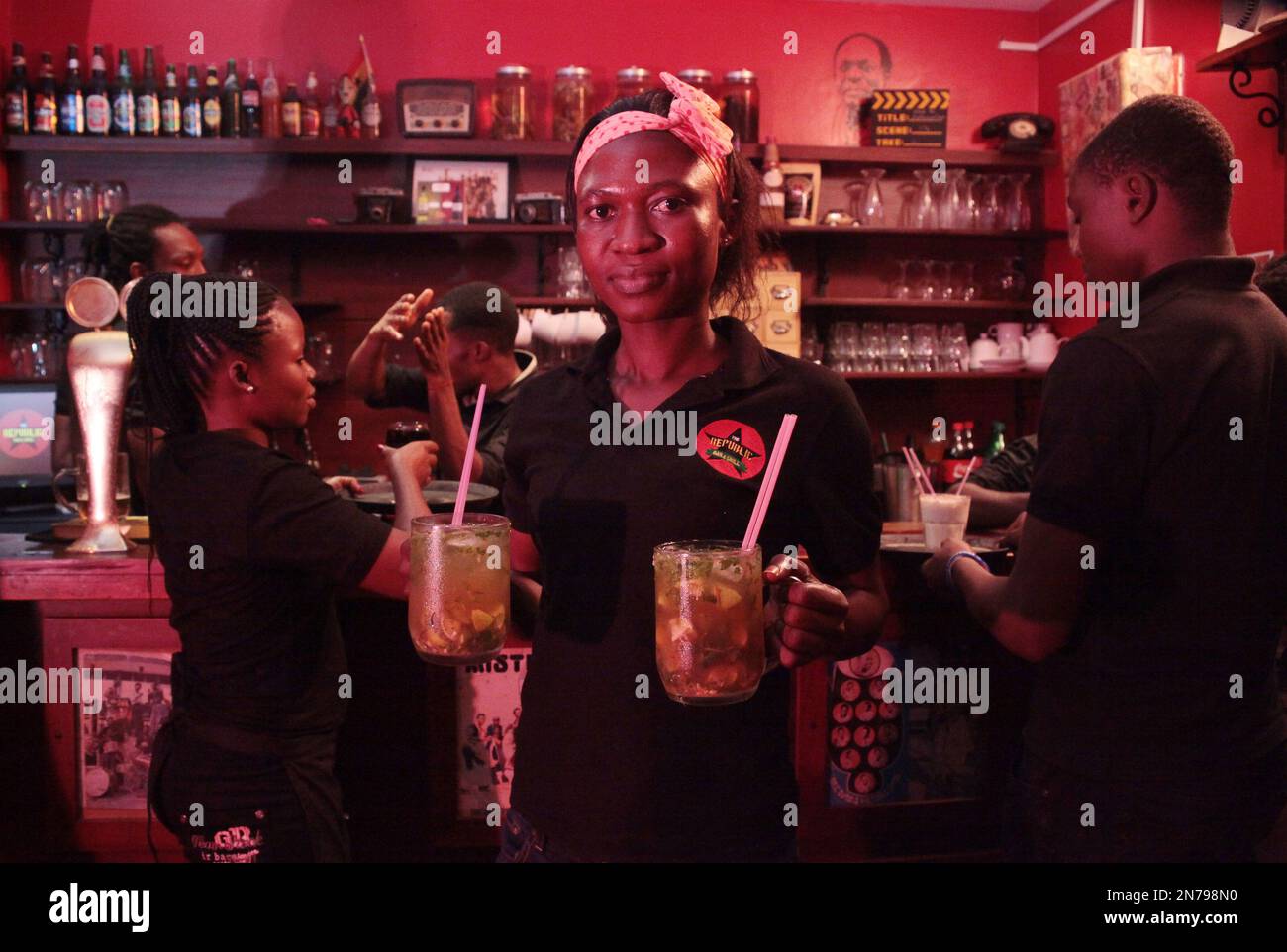 In this Friday, June 14, 2013 photo, waitress Habiba carries cocktails