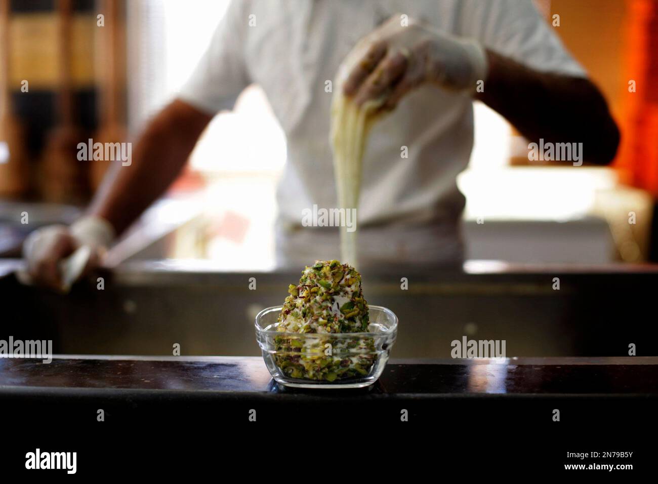 A Syrian worker prepares ice cream, at the Bakdash ice cream store, in