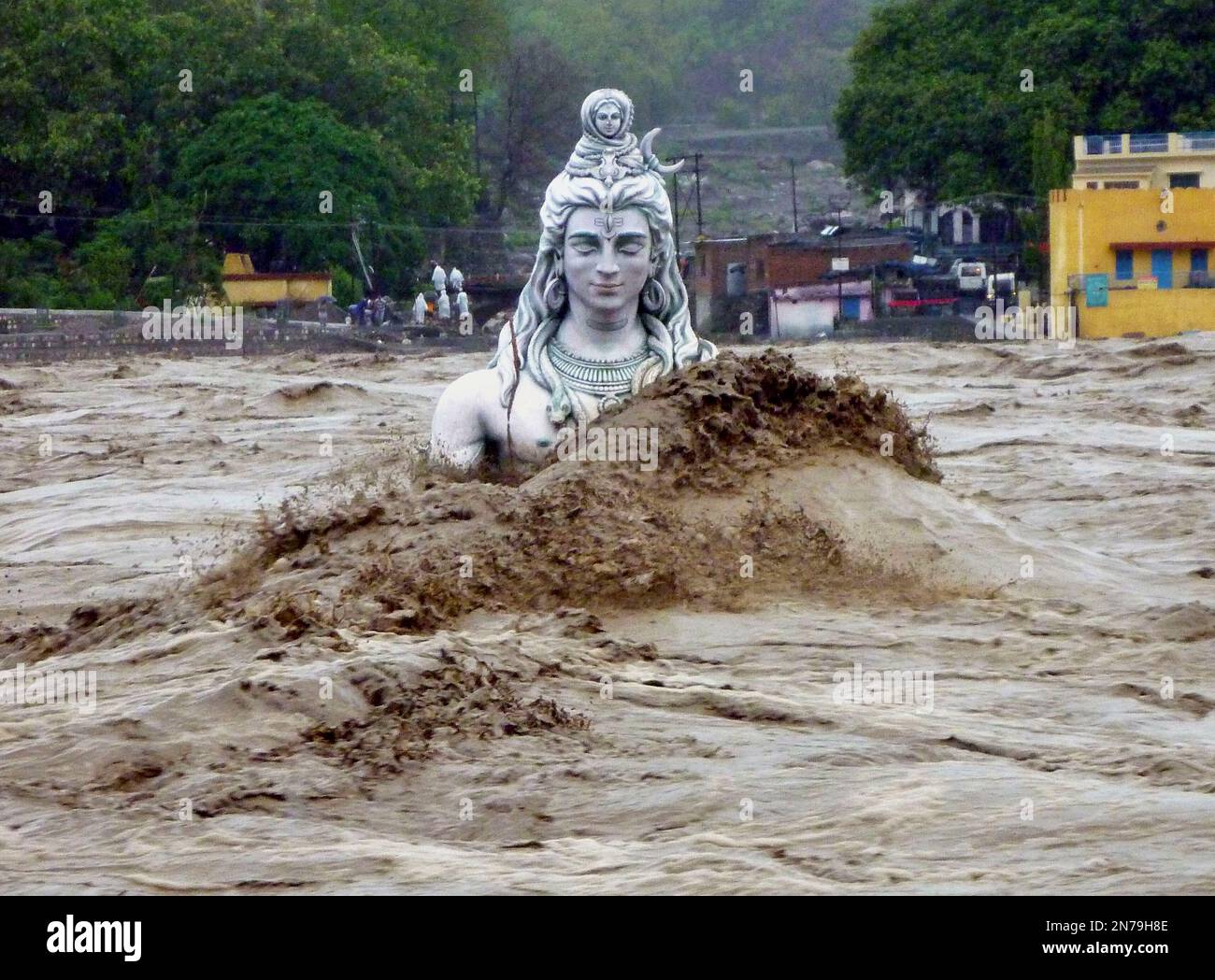 A submerged idol of Hindu Lord Shiva stands in the flooded River Ganges in Rishikesh, in the northern Indian state of Uttarakhand, India, Tuesday, June 18, 2013. Monsoon torrential rains have cause havoc in northern India leading to flash floods, cloudbursts and landslides as the death toll continues to climb and more than 1,000 pilgrims bound for Himalayan shrines remain stranded. (AP Photo) Stock Photo