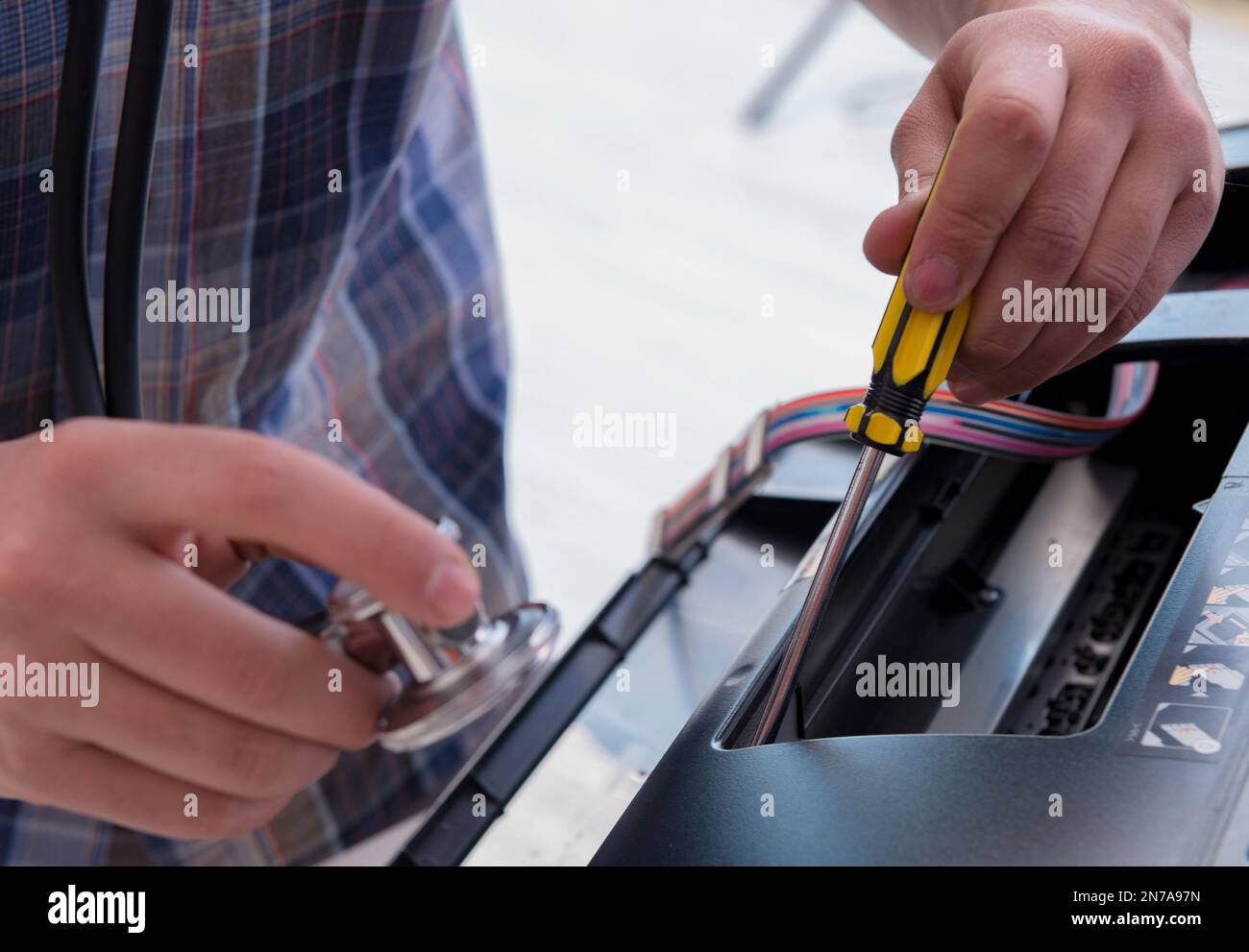 The repairman repairing broken color printer Stock Photo
