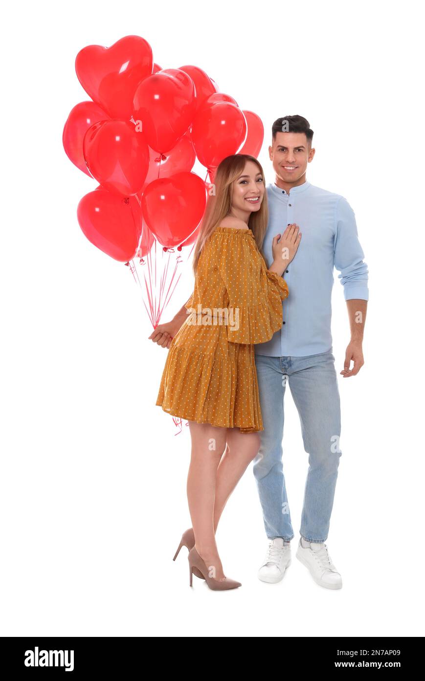 Lovely couple with heart shaped balloons on white background. Valentine ...
