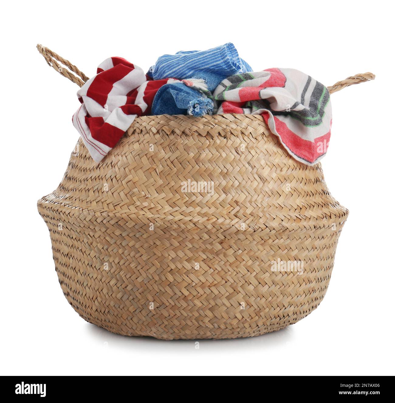 Wicker laundry basket with kitchen towels isolated on white Stock Photo