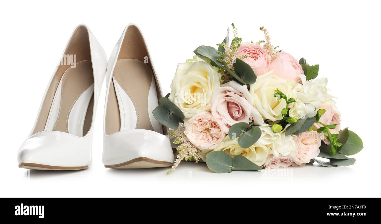 Pair of wedding high heel shoes and beautiful bouquet on white background Stock Photo