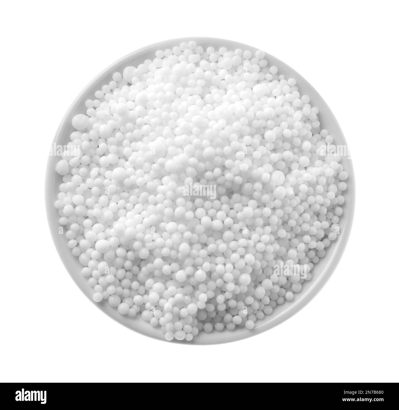 Pellets of ammonium nitrate isolated on white, top view. Mineral fertilizer Stock Photo