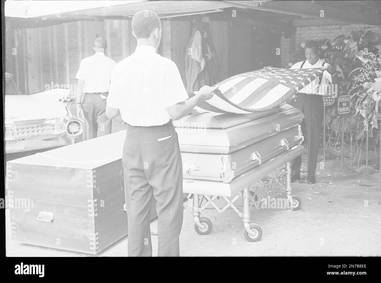 FILE In this June 16, 1963 file photo, funeral home attendants drape