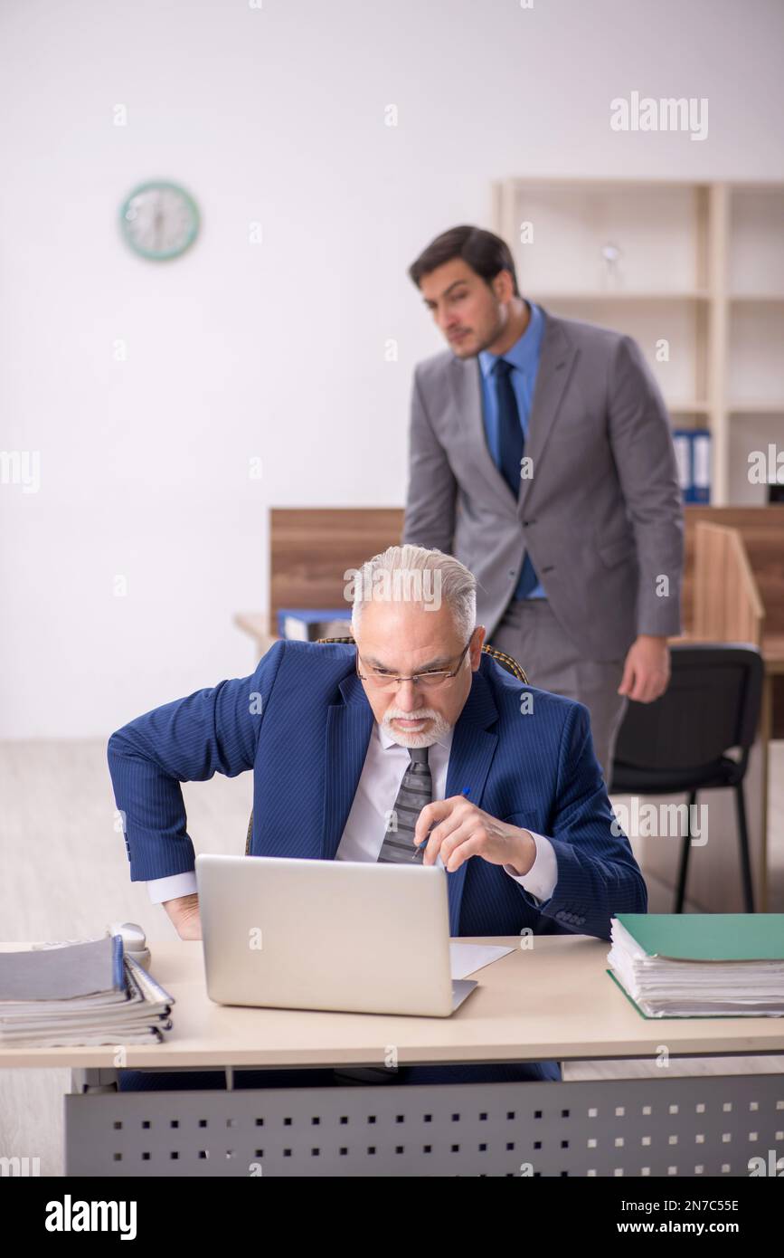 Two colleagues working at workplace Stock Photo