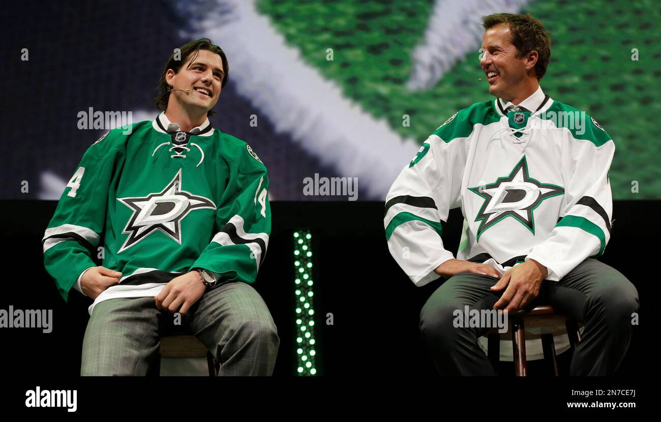 Former Dallas Stars Mike Modano right and current left wing Jamie Benn wear the team s new logo on hockey jerseys during an unveiling of the new design in Dallas Tuesday Sunday June