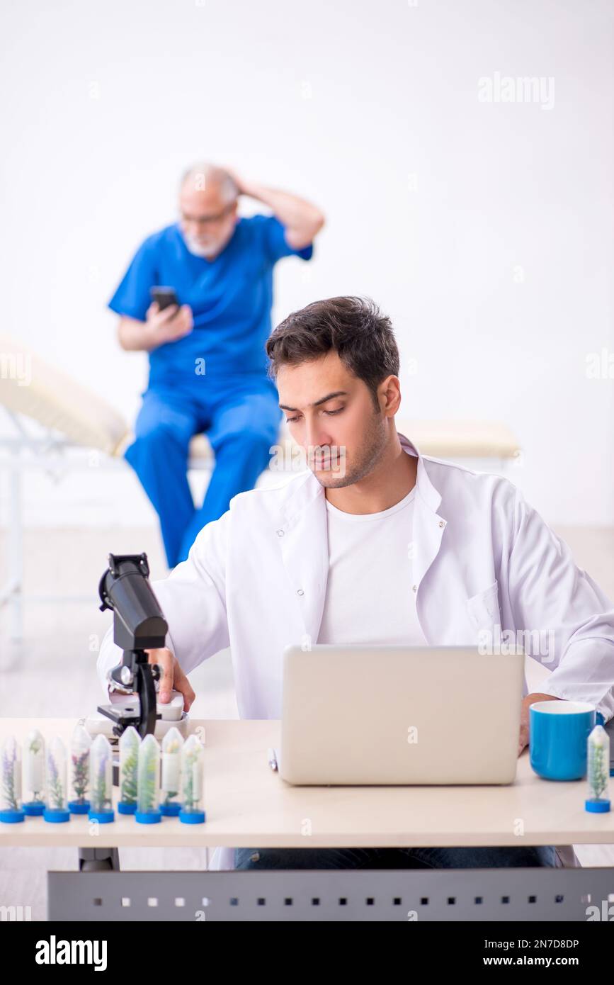 Two chemists in drugs synthesis concept Stock Photo Alamy