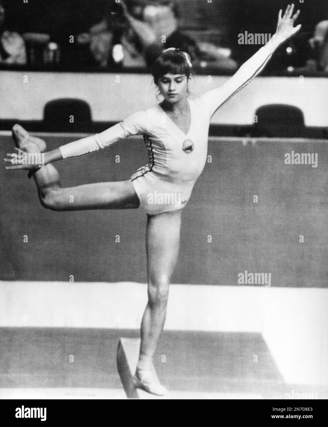 Romanian 14 year old gymnast Nadia Comaneci performs on the beam during