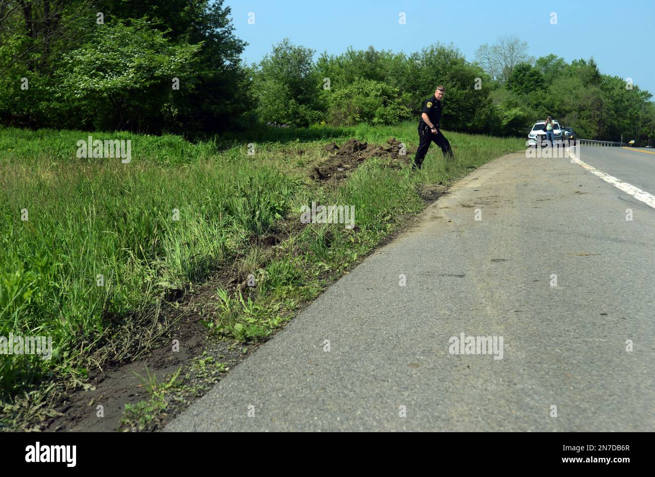 Cortland County Sheriffs Deputy John Gallagher, center, surveys the