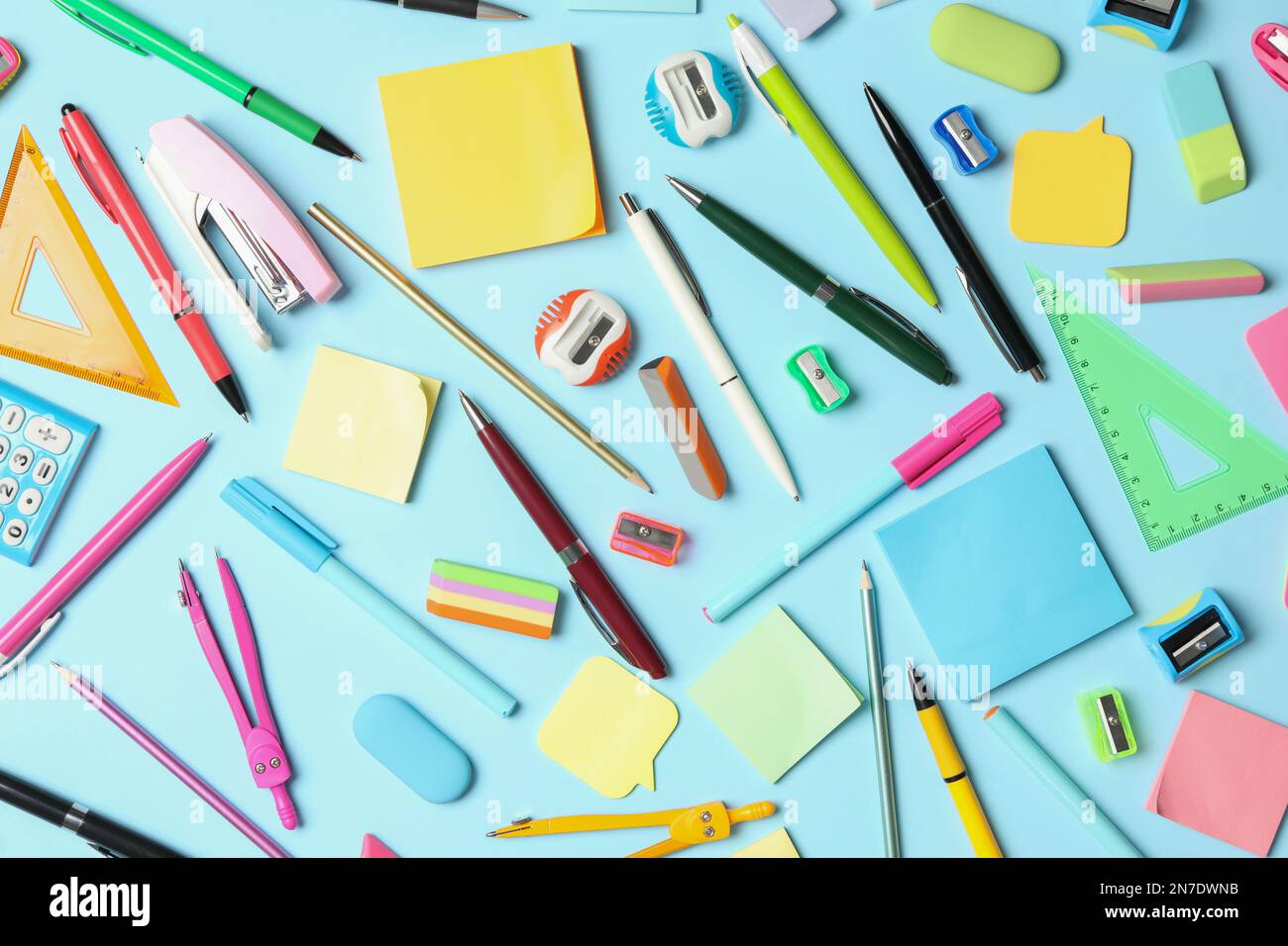 Flat lay composition with different school stationery on light blue ...