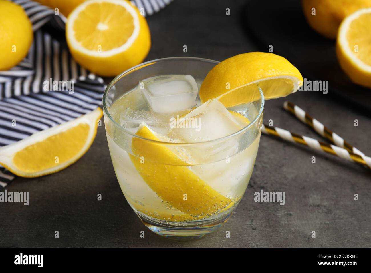 Soda water with lemon slices and ice cubes on grey table Stock Photo ...