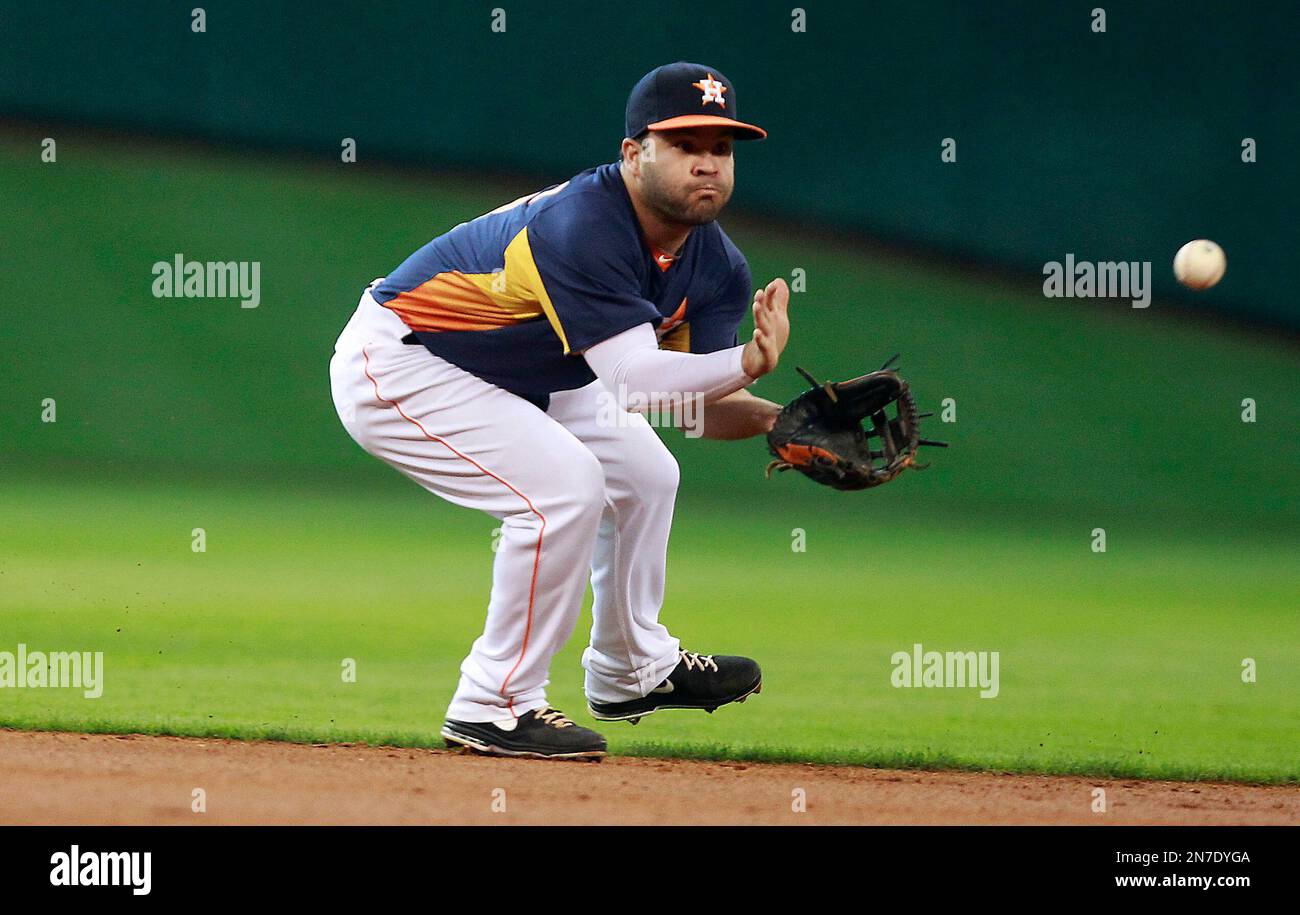 Houston Astros second baseman Jose Altuve fields a ground ball hit by  Oakland Athletics' Chris Young in the first inning during a baseball game,  Sunday, May 26, 2013, in Houston. (AP Photo/Patric