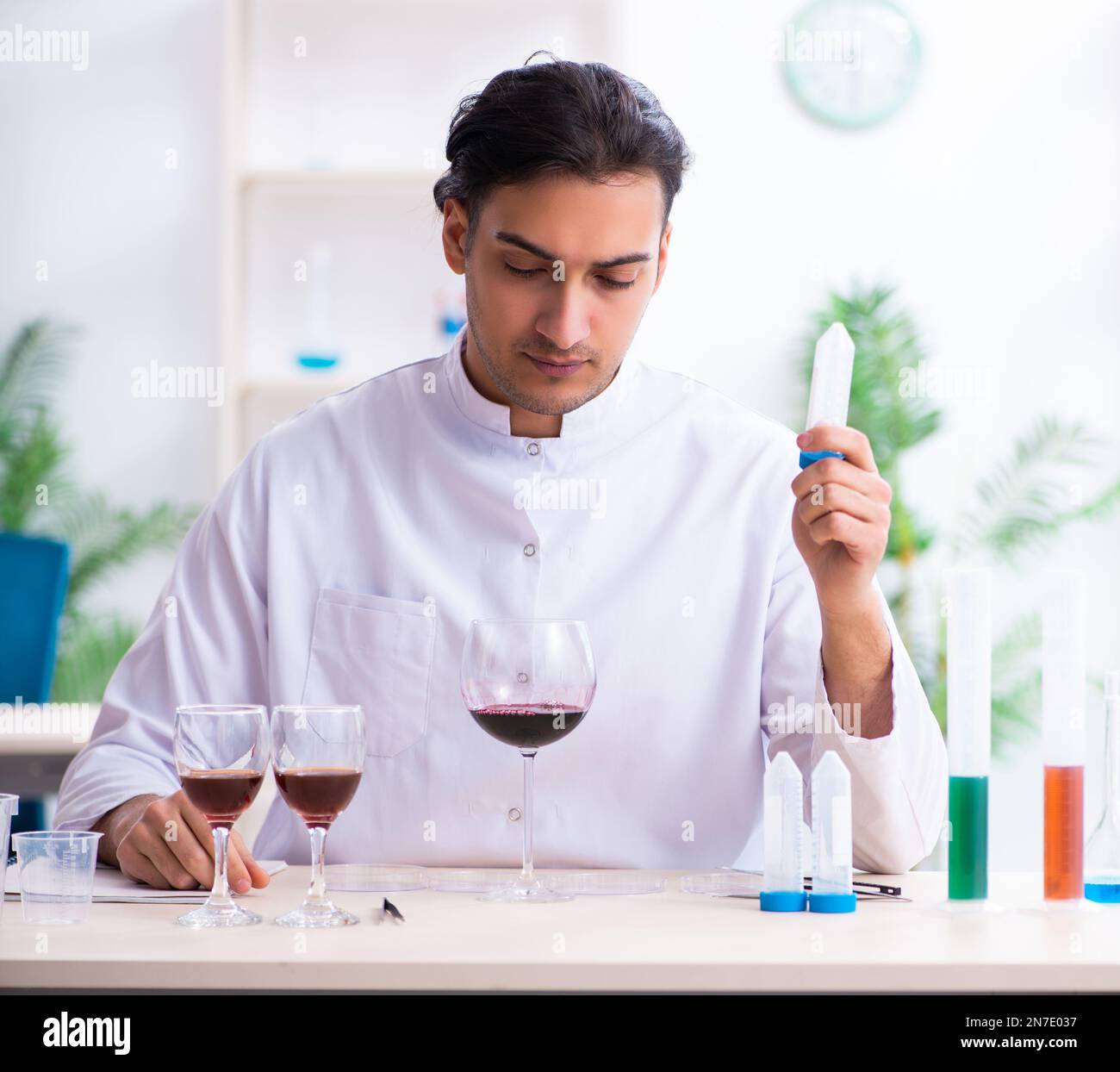 The male chemist examining wine samples at lab Stock Photo Alamy