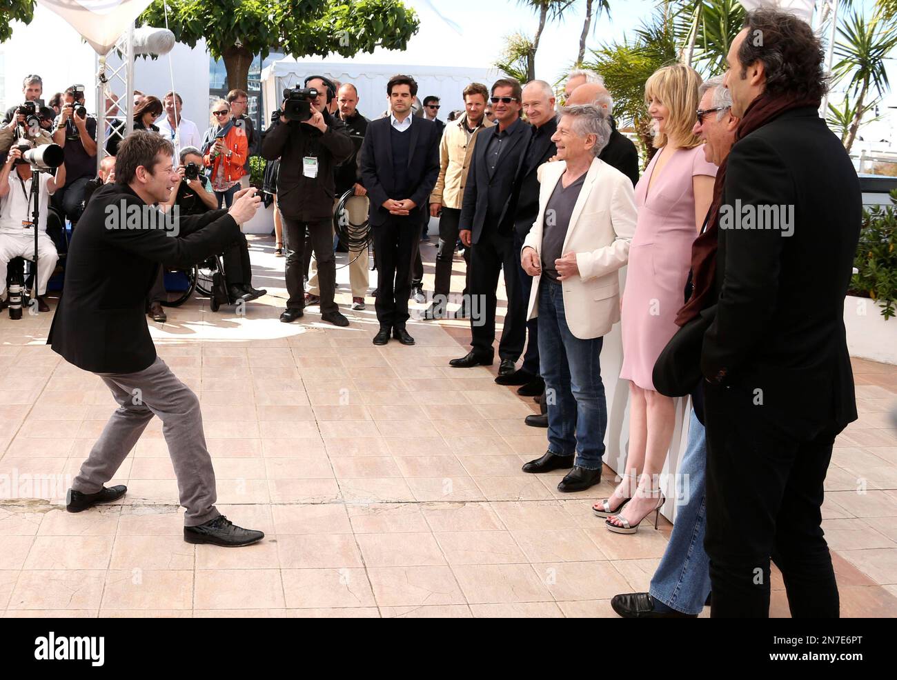 Actor Mathieu Amalric takes a photo of fellow cast and crew members ...