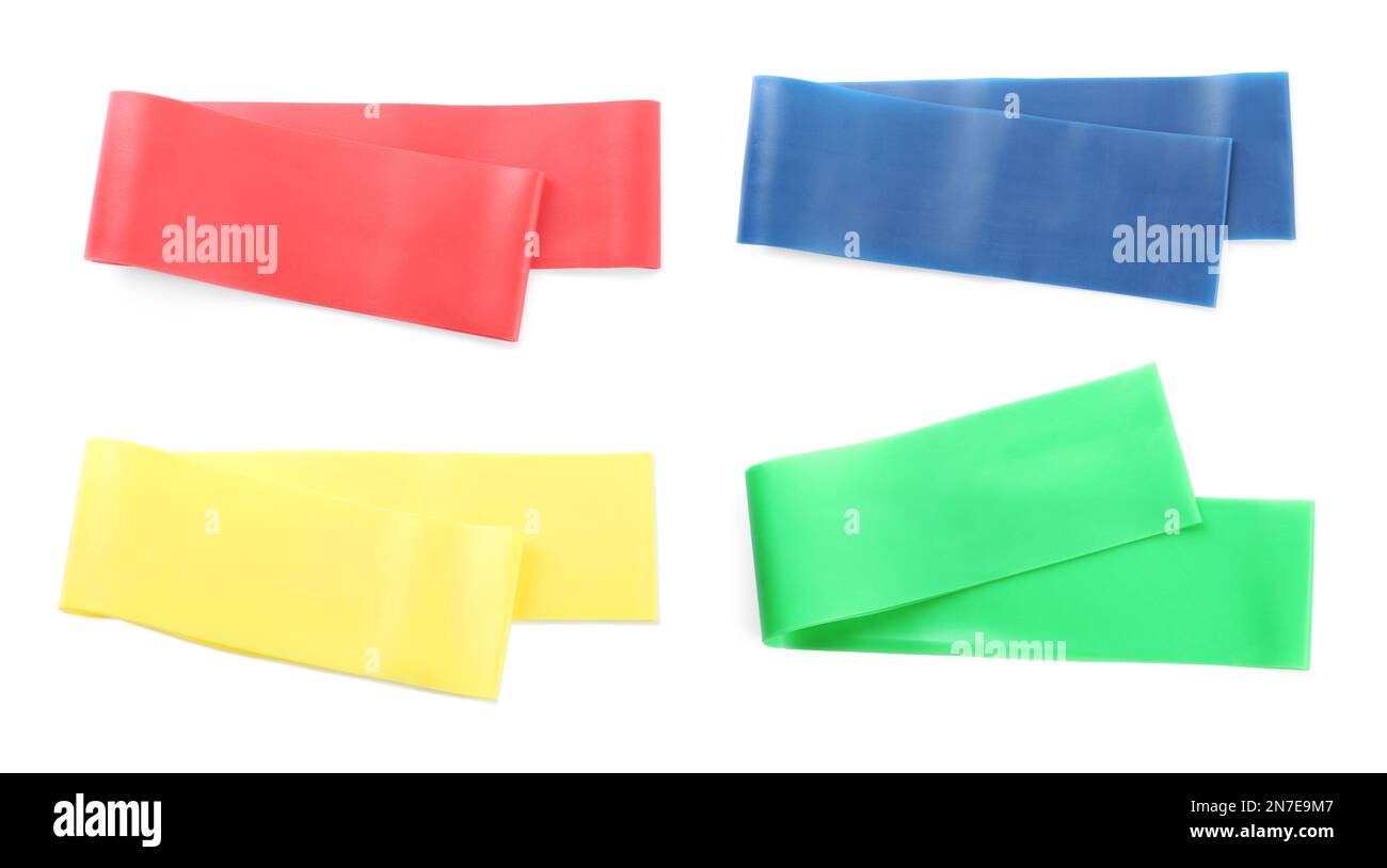 Set of different fitness elastic bands on white background, top view
