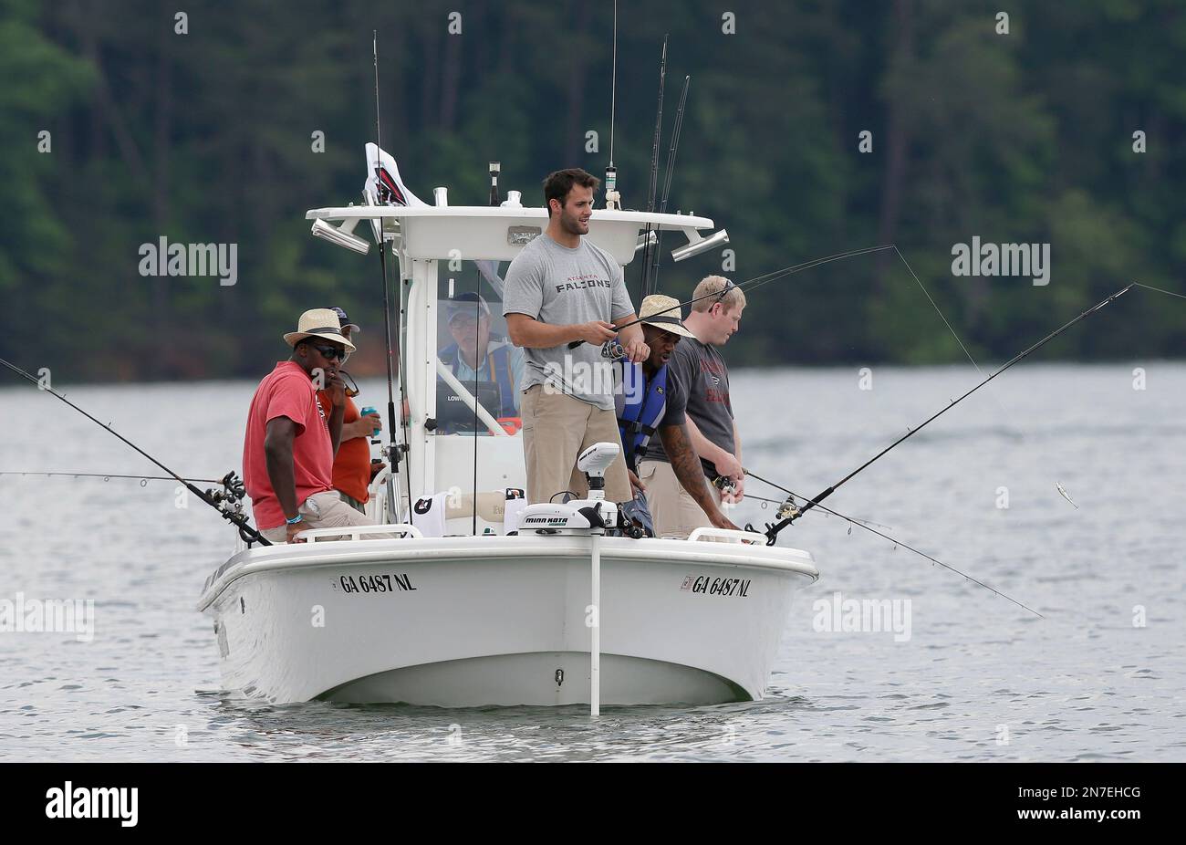 Atlanta Falcons players from left; Malliciah Goodman, Nick Clancy, and  Robert James fish with wounded veteran Richard Robinson, right, on Lake  Lanier in Buford, Ga., Wednesday, May 22, 2013. Fishing with the