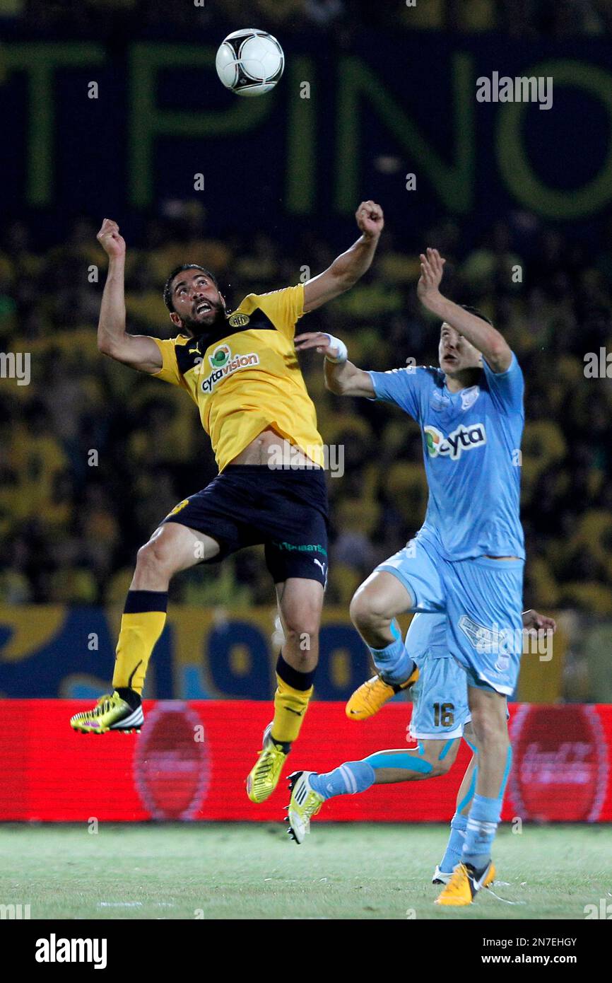 Aggelis Charalambous, right, of Apollon, Limassol, jumps for the ball with Michalis Constantinou, left, of AEL Limassol during their final cup soccer match at Tsirion stadium in southern port city of Limassol,