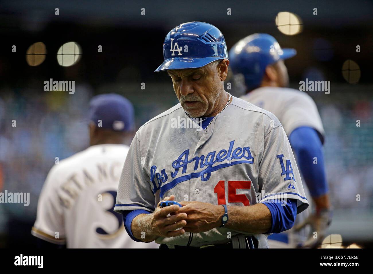 Los Angeles Dodgers first base coach Davey Lopes looks at a stopwatch  during the second inning of a baseball game against the Milwaukee Brewers  Tuesday, May 21, 2013, in Milwaukee. (AP Photo/Morry