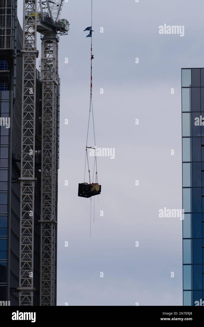 Construction crane lifting heavy weight on a building site Melbourne
