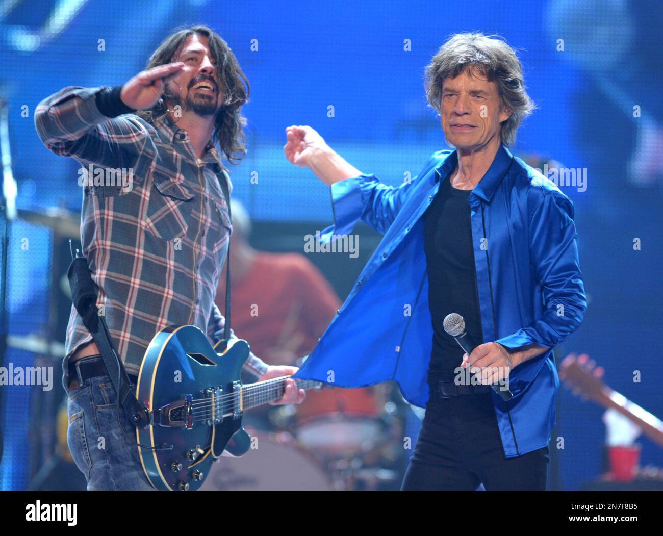 Dave Grohl, left, performs with Mick Jagger of the Rolling Stones on