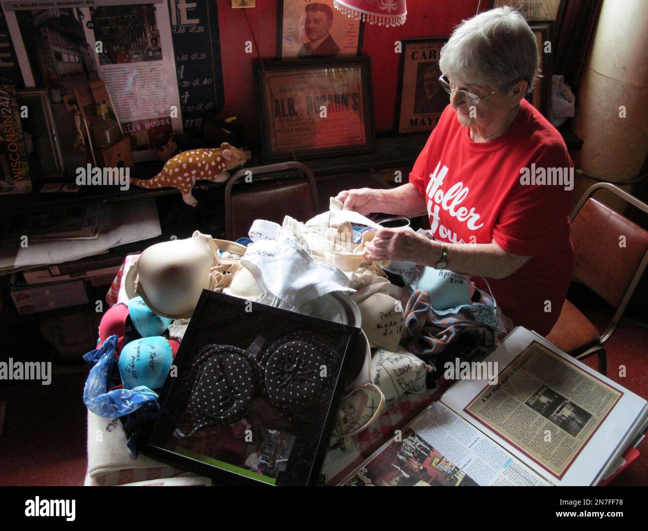Marcy Skowronski, 87, looks through a pile of bras Friday, May 17, 2013