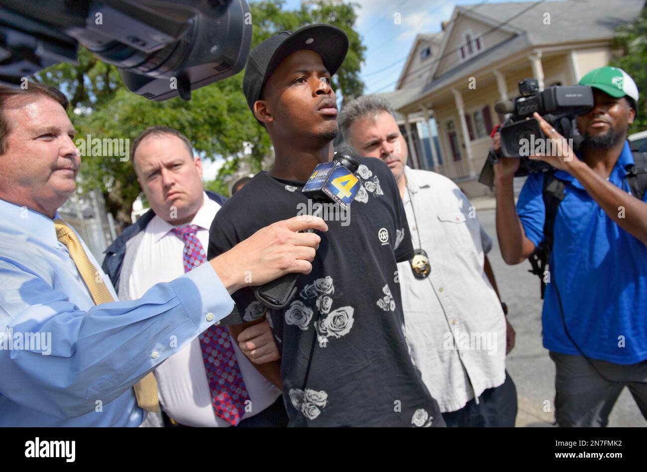 Shawn Scott, 24, a suspect in the Mother's Day parade shooting is led