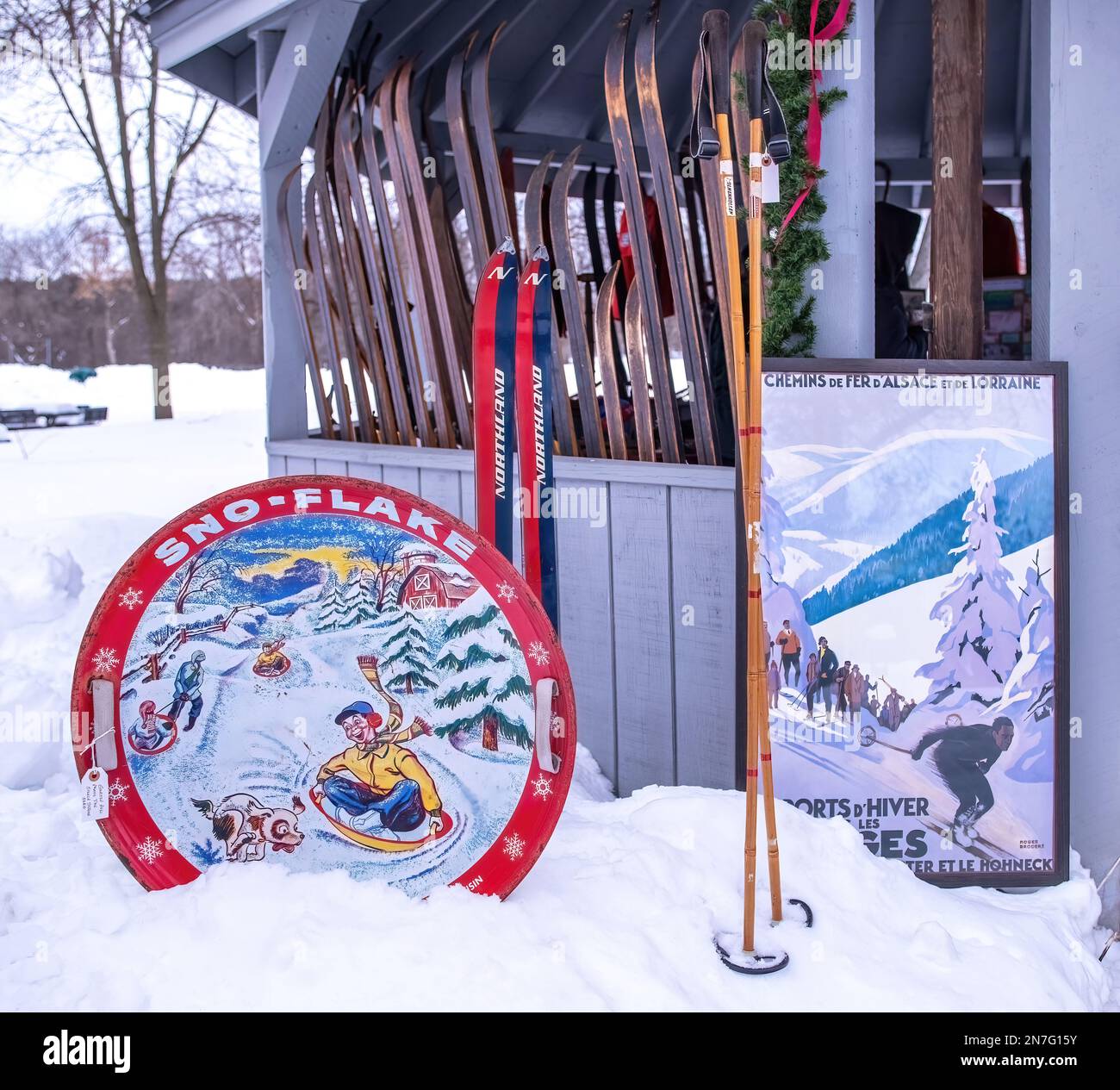 Vintage Sno-Flake metal snow saucer, ski poles and skis, and poster at the Barton Johnson Park Gazebo for the 18th Annual Vinterfest in Scandia, Minn. Stock Photo