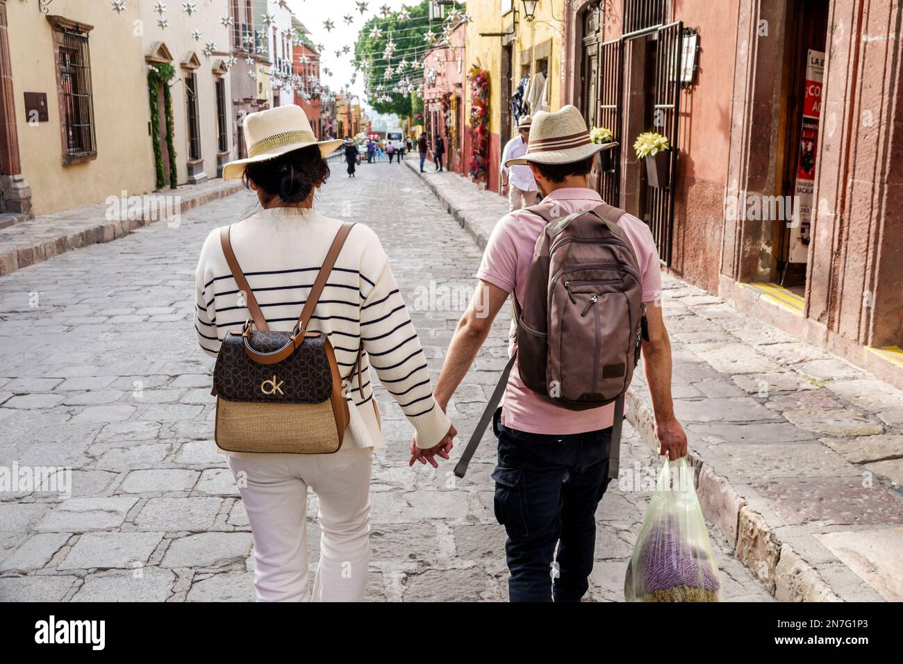 San Miguel de Allende Guanajuato Mexico,Historico Central historic center Zona Centro,holding hands,wearing hat hats fedora fedoras,man men male,woman Stock Photo