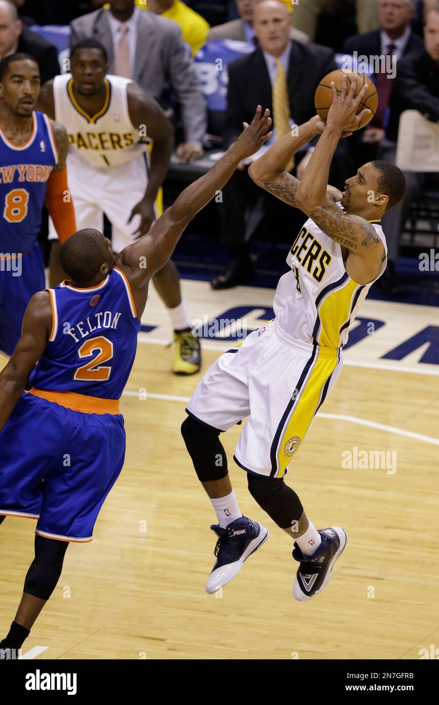 Indiana Pacers guard George Hill, right, shoots over New York Knicks guard Raymond Felton during the first half of Game 3 of the Eastern Conference semifinal NBA basketball playoff series in Indianapolis, Saturday, May 11, 2013. (AP Photo/Michael Conroy) Stock Photo