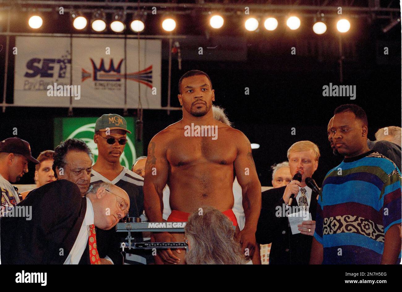 Boxing officials watch as former heavyweight champion Mike