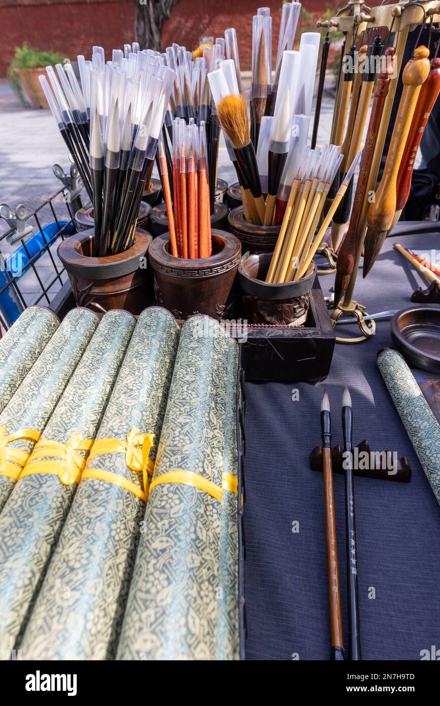 Calligraphy brushes and scrolls on sale at a roadside stall in Taipei