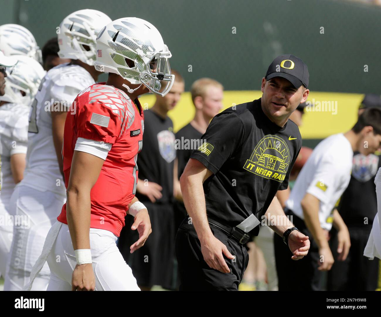 Oregon football coach Mark Helfrich, right, is shown with quarterback