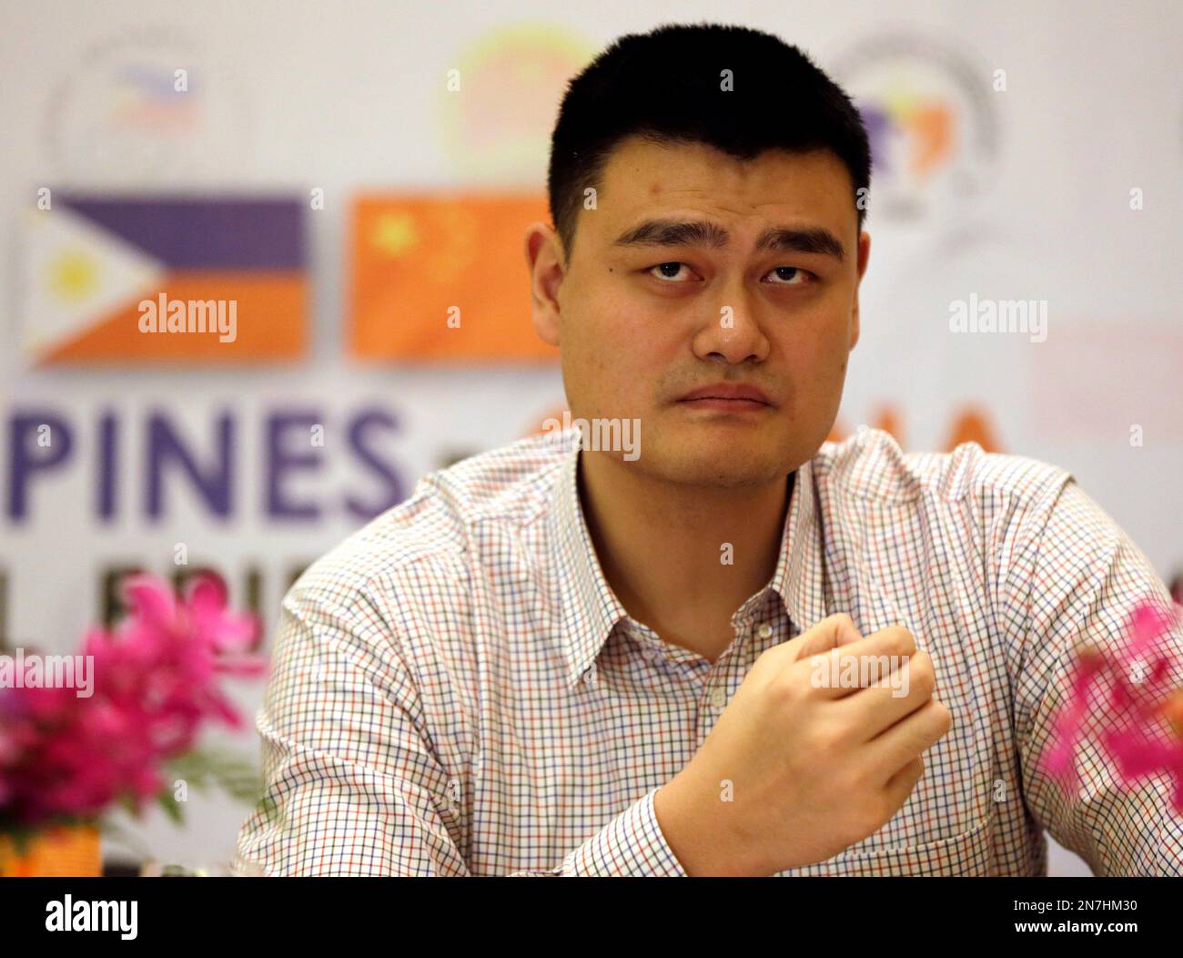 Former NBA Houston Rockets basketball player Yao Ming listens to a