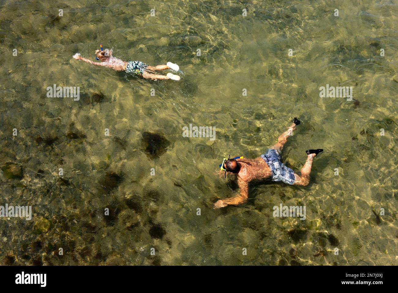 Father and son snorkelling at Heiligenhafen's beach. Stock Photo