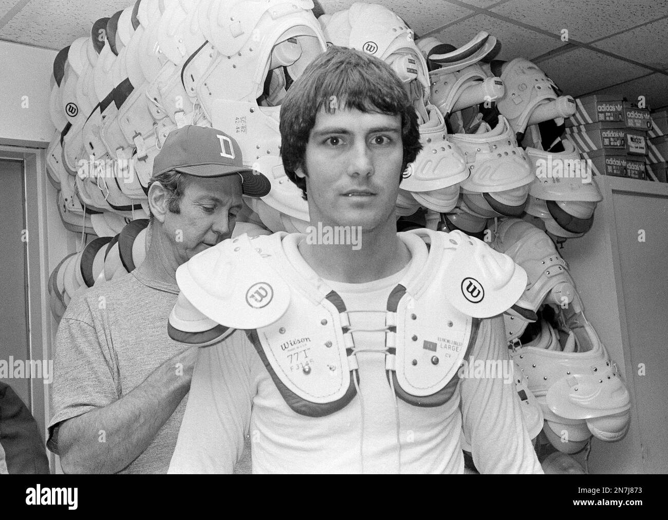 Dallas Cowboys quarterback Danny White gets a helping hand from