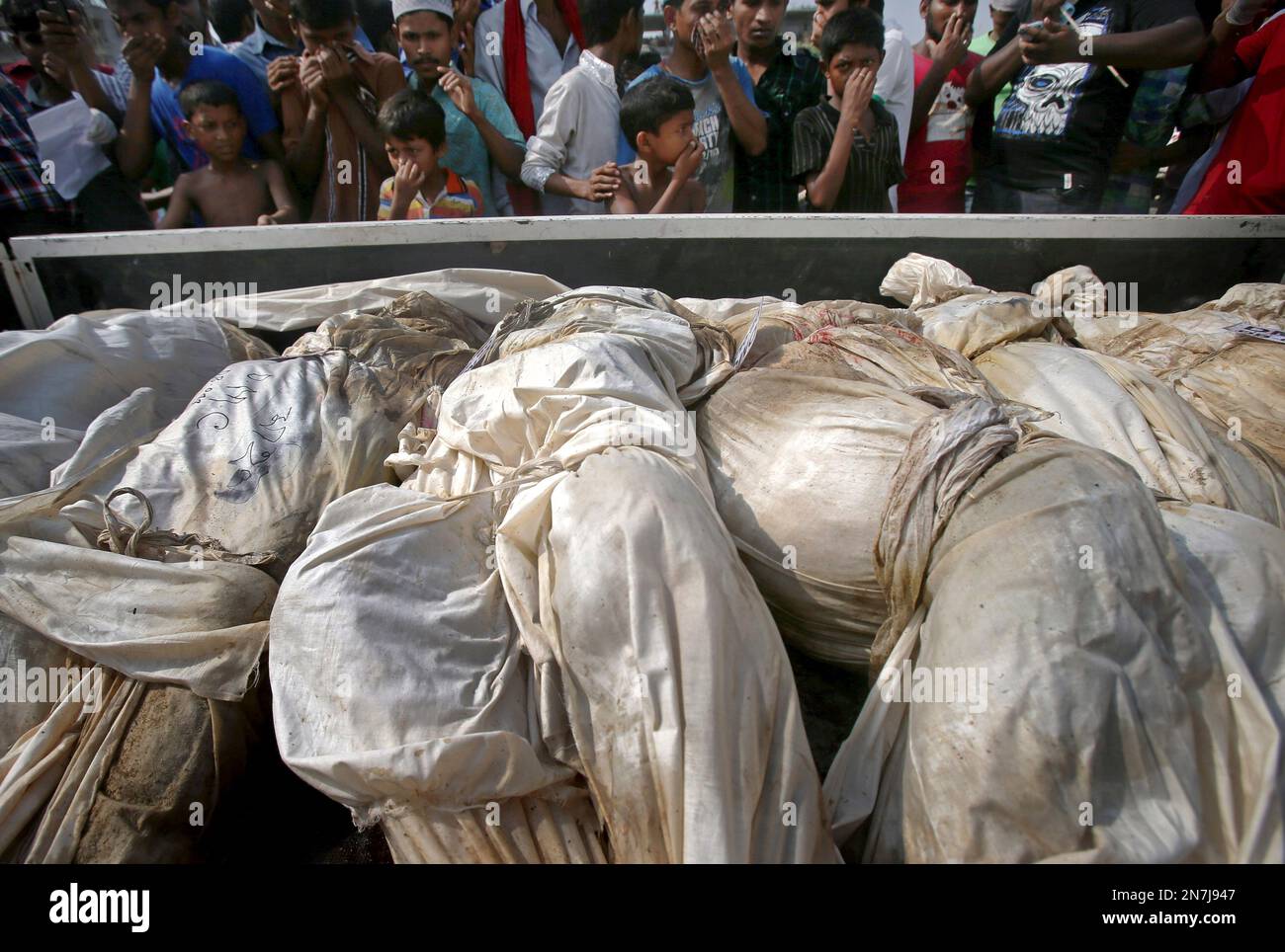 People cover their noses to block out the smell of bodies