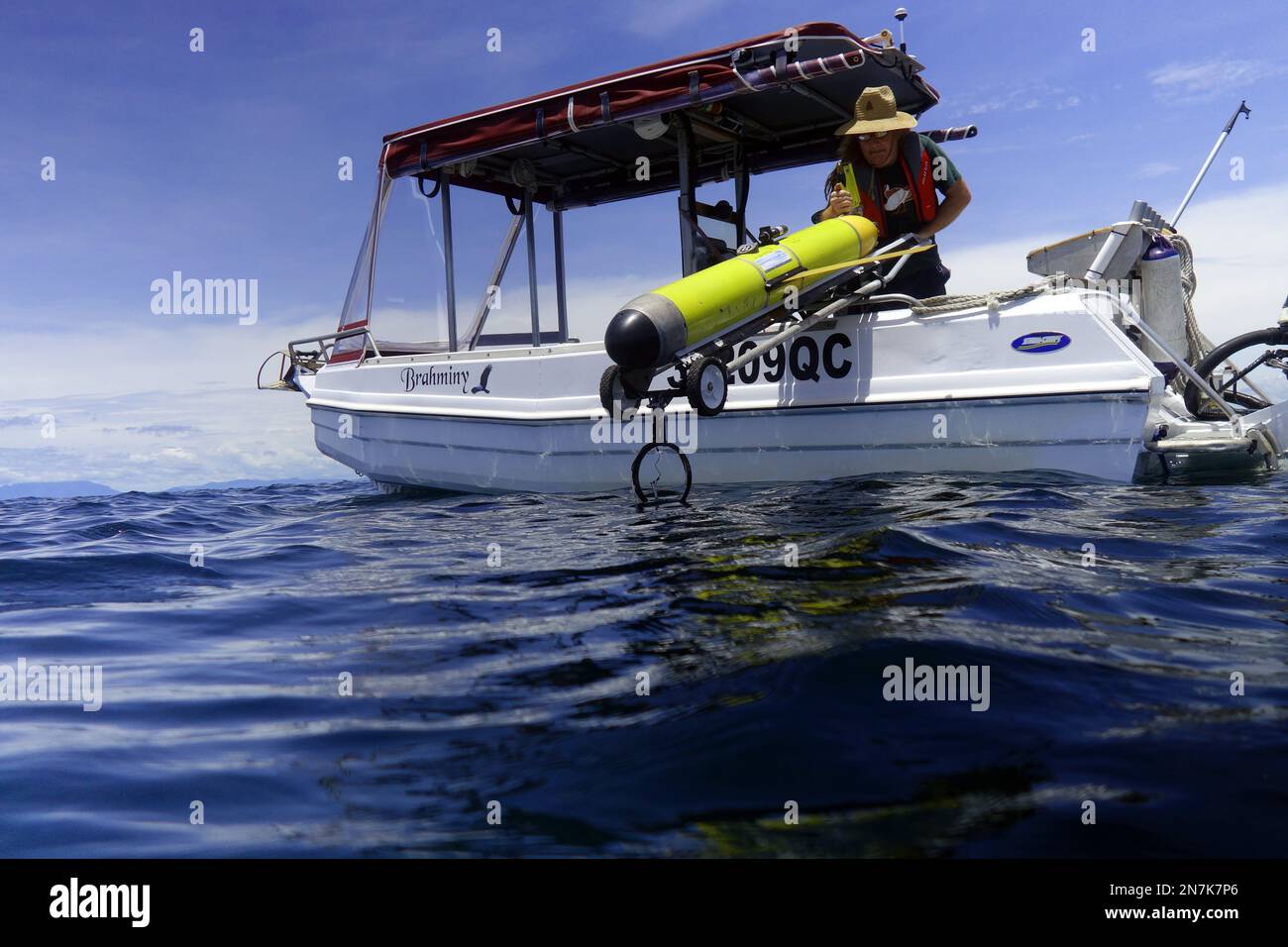 Slocum ocean glider (yellow) being deployed from small charter vessel, Mission Beach, Great Barrier Reef, Queensland, Australia. No MR or PR Stock Photo