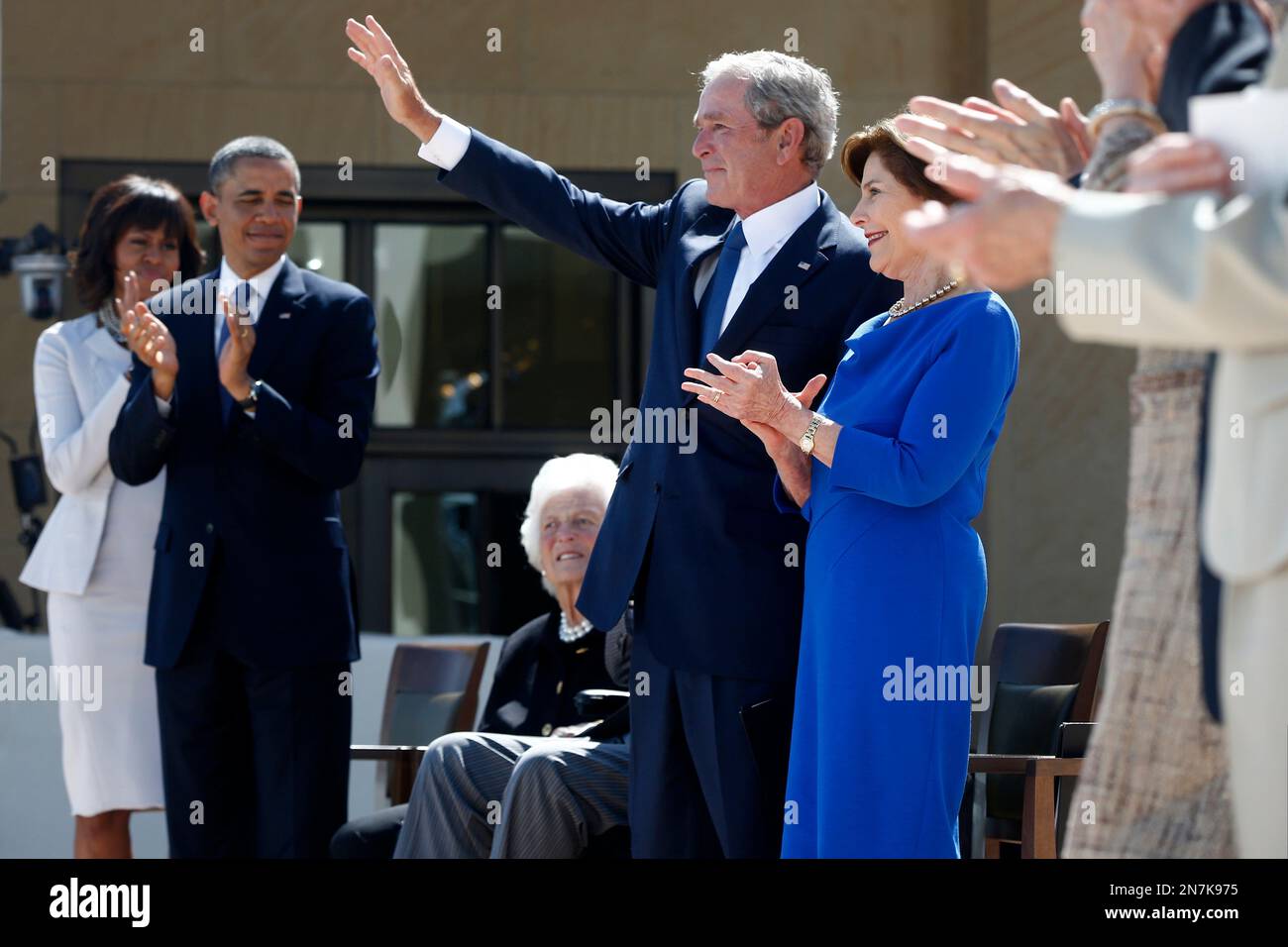 Former President George W. Bush waves after speaking at the dedication ...