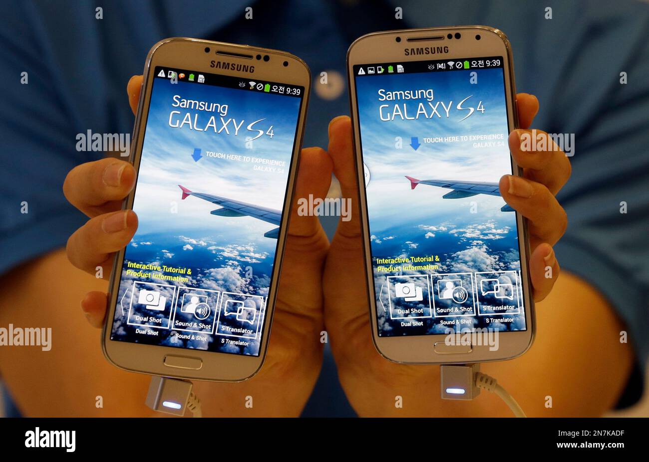 A model shows Samsung Electronics Co.'s latest Galaxy S4 smartphones during  its unveiling ceremony in Seoul, South Korea, Thursday, April 25, 2013. The Galaxy  S4 will go on sales in the domestic