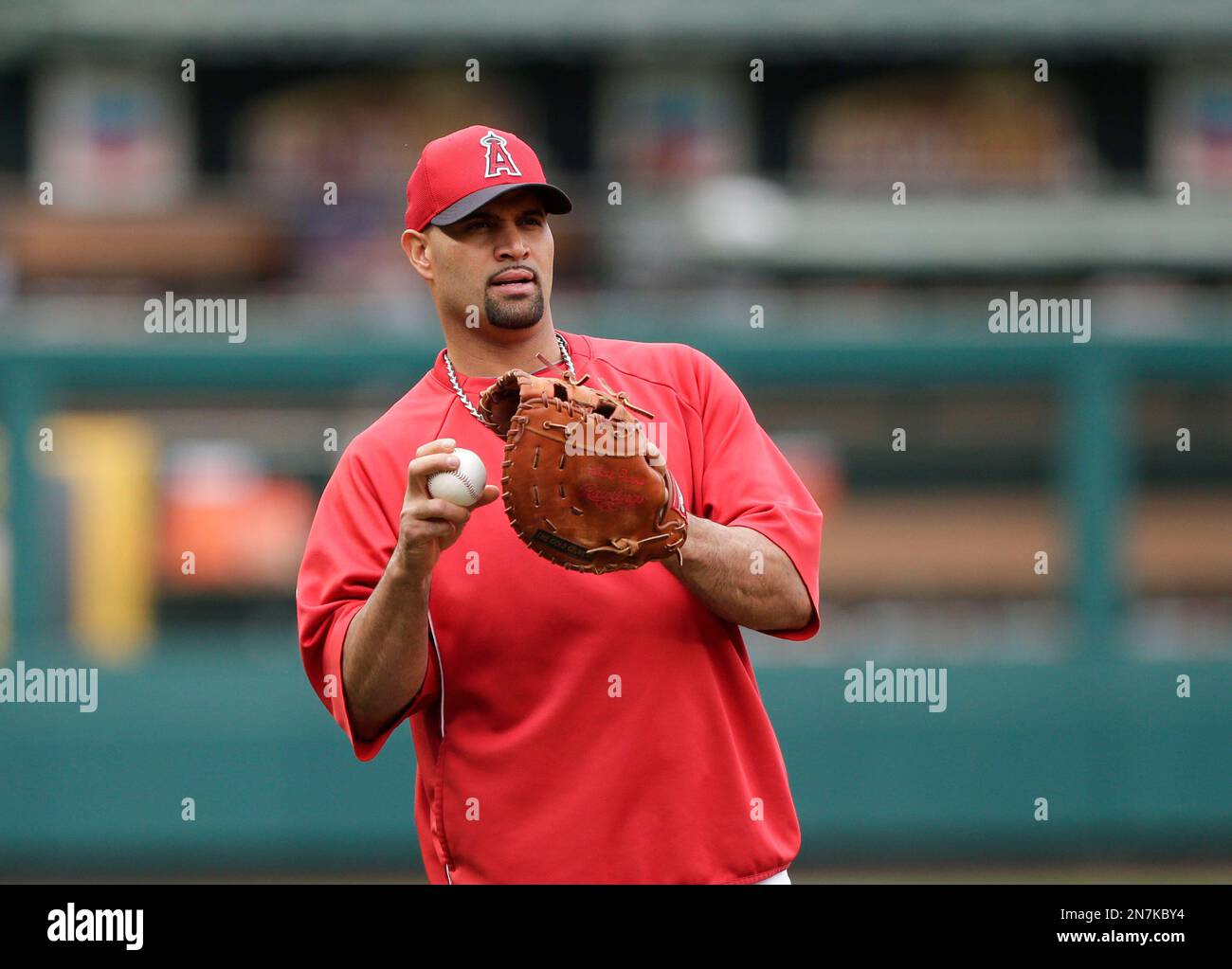 While Anaheim Angels Albert Pujols looks on, St. Louis Cardinals Matt  Holliday and his wife Leslee make their remarks after accepting the Pujols  Family Foundation's Gina Kelly Partner of the Year Award