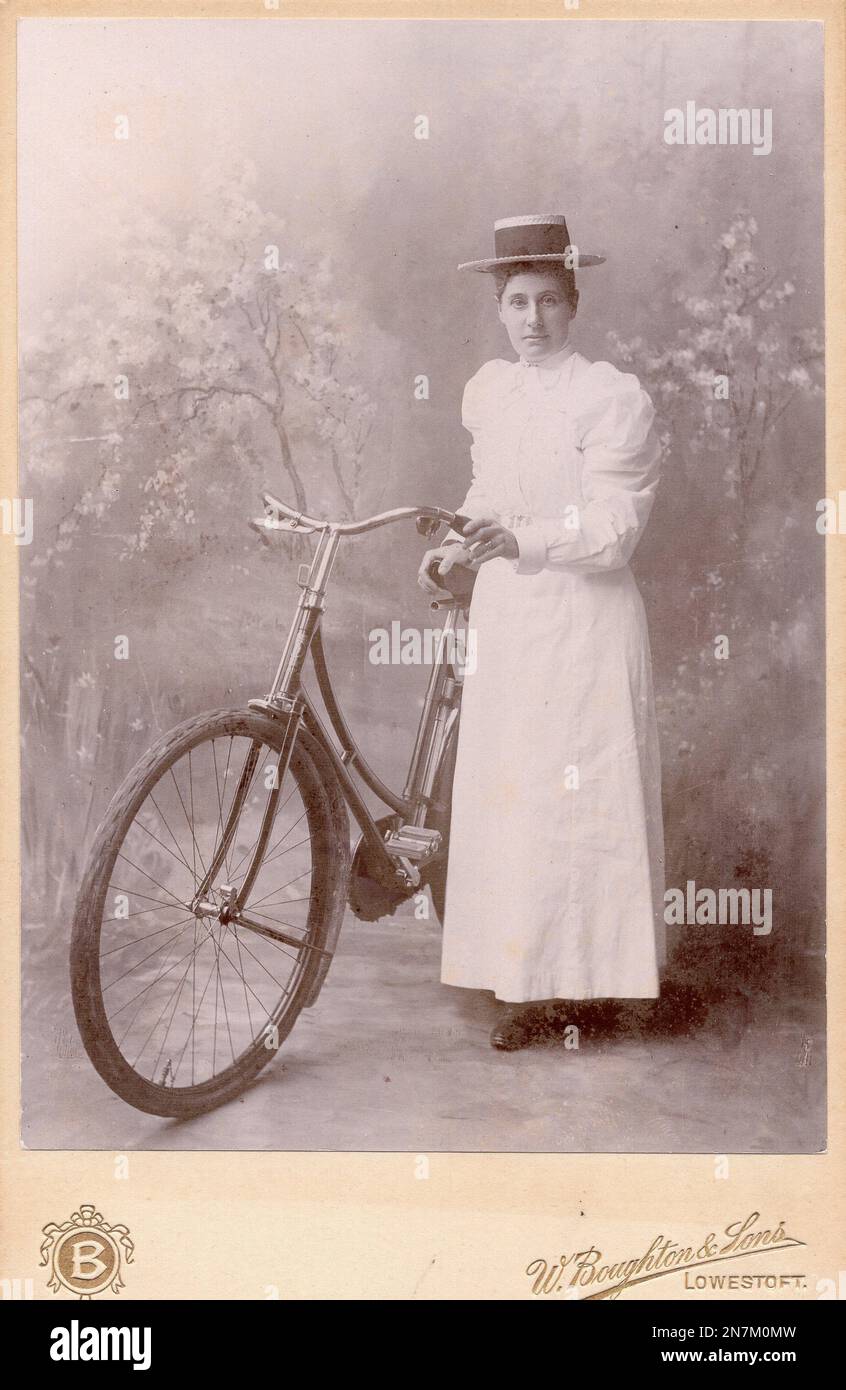 Cabinet card image of a lady & her bicycle by Broughton of Lowestoft UK Stock Photo